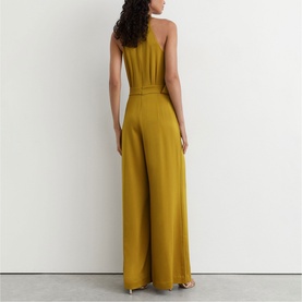Model wearing Reiss chartreuse green wide-leg halterneck jumpsuit with belted waist, back view