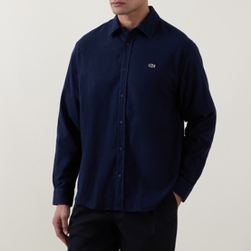 Model wearing Lacoste navy blue cotton casual shirt with small logo embroidery on chest, button-front and long sleeves
