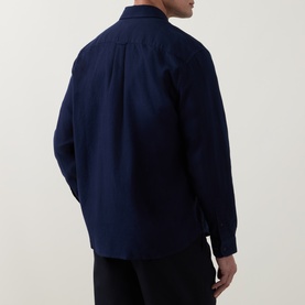 Model wearing Lacoste navy blue cotton casual shirt, back view, styled with black trousers