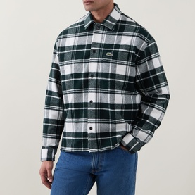 Model wearing Lacoste Casual Shirt in Flour colourway, green and white tartan check, 100% cotton, styled with blue denim jeans.