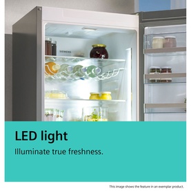 Siemens SDA Built-In Fridge-Freezer interior showing LED lighting illuminating shelves stocked with food and drinks.