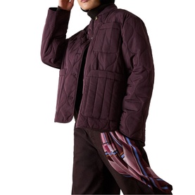 Model wearing Whistles red quilted jacket with chest pockets, styled with dark trousers and a plaid scarf
