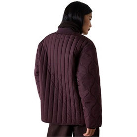 Model wearing Whistles red quilted jacket, shown from behind with vertical stitch detailing and funnel neck