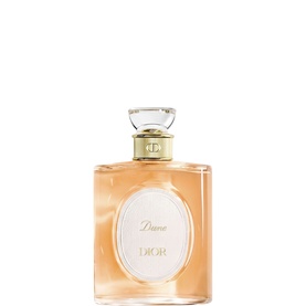 Dior Dune Eau de Toilette in a rounded peach-tinted glass bottle with gold cap and oval label