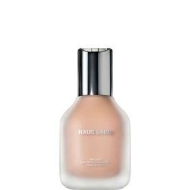 Haus Labs Triclone Skin Tech Foundation in a glass bottle with silver cap, nude beige tone