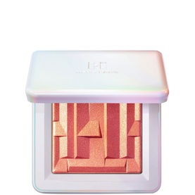 Haus Labs Bio-Radiant Gel-Powder Highlighter in Fire Opal, open compact showing peach-pink pressed powder with geometric relief pattern