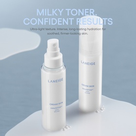 Laneige Cream Skin face mist in white bottle alongside matching product, styled on light blue surface with milky texture splash