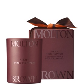 Molton Brown Fiery Pink Pepper Scented Candle in deep red vessel with matching gift box and orange ribbon bow.