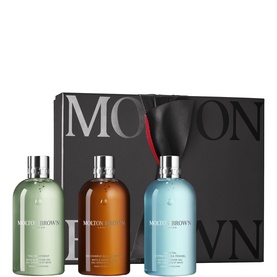Molton Brown Bath & Body gift set with three large bottles in green, amber, and blue, presented with signature black gift box