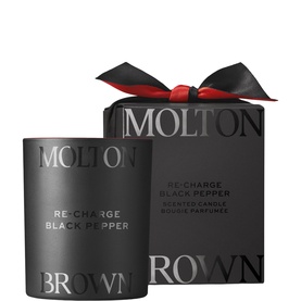 Molton Brown Re-Charge Black Pepper Scented Candle in matte black vessel, shown with matching black gift box and red bow.