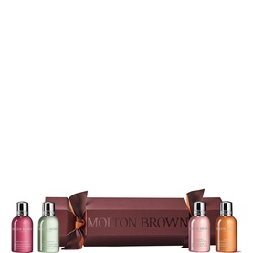 Molton Brown Bath & Body gift cracker set with four miniature body wash bottles in assorted shades, presented in burgundy cracker packaging