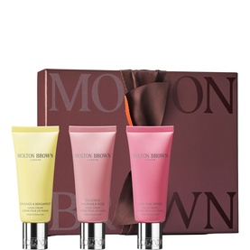 Molton Brown hand care gift set featuring three tubes in yellow, pink, and coral with silver caps, presented with branded box.
