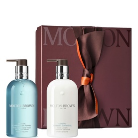 Molton Brown bath and body gift set with two pump bottles in burgundy ribbon-tied box