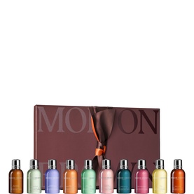 Molton Brown bath and body gift set with ten assorted miniature bottles in multicolour, presented in a branded burgundy gift box.