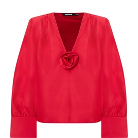 Rotate blouse in Scooter Red with deep V-neck, 3D rose corsage detail, and puffed cuffed sleeves in satin finish