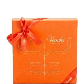 Venchi orange gift box tied with satin ribbon, featuring gold illustrated floral motif and Venchi branding