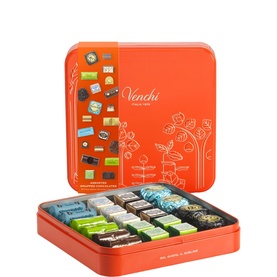 Venchi multi-flavour chocolate gift tin in orange, open lid showing assorted wrapped chocolates in rows