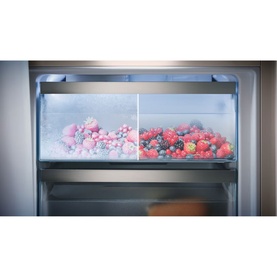 Miele Built-in 70/30 Fridge-Freezer PerfectFresh Active drawer showing fresh and frozen berries, stainless steel interior