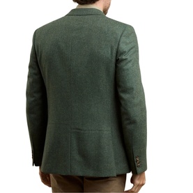 Model wearing Magee 1866 green wool blazer, rear view, styled with tan trousers, notched lapel and single vent detail visible.