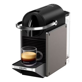 Krups Nespresso Pixie Titanium coffee machine in black, compact design with chrome accents, shown with espresso cup on drip tray