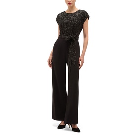 Model wearing Hobbs black wide-leg jumpsuit with sequin lace bodice, cap sleeves, and tie waist belt, styled with black heels