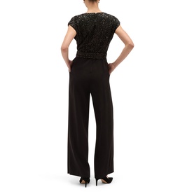 Model wearing Hobbs black wide-leg jumpsuit with sequin embellished cap sleeve top, shown from behind