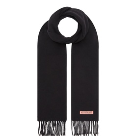 Acne black wool scarf with fringe ends and signature pink logo patch, displayed flat against white background