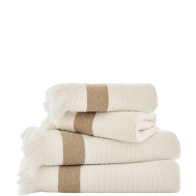 The Lyndon Company Natural towel set of four, ribbed cotton with contrasting tan stripe and fringe detail, stacked neatly