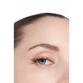 Model with Chanel eye liner in gold, shown applied to upper lash line with a glittery metallic finish
