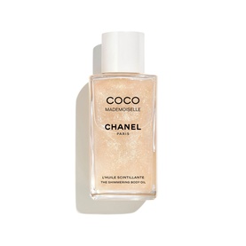 Chanel Coco Mademoiselle The Shimmering Body Oil in a white cap bottle with golden shimmer formula visible