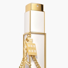 Chanel fragrance set in white and gold-tone bottle with decorative gold house charm chain pendant detail