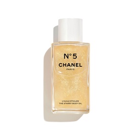 Chanel N&deg;5 The Starry Body Oil in a gold glitter-filled bottle with white cap