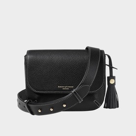 Aspinal of London black pebbled leather crossbody bag with gold-tone studs, contrast stitching, tassel detail, and adjustable shoulder strap.