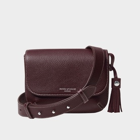 Aspinal of London wine pebbled leather crossbody bag with flap closure, stud-detail strap, silver hardware, and tassel charm
