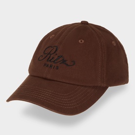 FRAME DENIM Emblem Logo Baseball Cap in brown cotton, six-panel design with embroidered Ritz Paris script and adjustable back strap.
