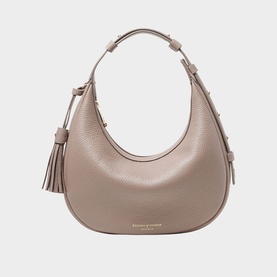 Aspinal of London taupe pebbled leather hobo bag with gold-tone hardware, tassel detail, and short top handle with adjustable strap