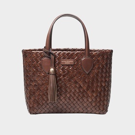 Brown woven leather tote bag with dual top handles, gold-tone hardware, and tassel detail, structured silhouette