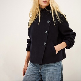Model wearing Bash blue short wool-blend coat with button fastening and high neck, styled with light blue jeans