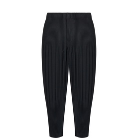 Issey Miyake black pleated tapered trousers in 100% polyester with elasticated waistband