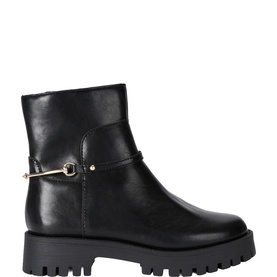Steve Madden black leather ankle boot with gold-tone buckle strap detail and chunky lug sole, side profile view