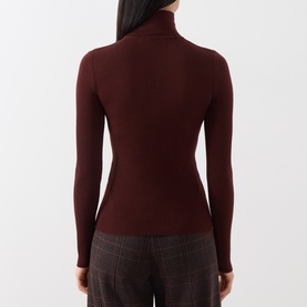 Model wearing Max Mara Main brown wool turtleneck top, long sleeves, ribbed fitted silhouette, shown from the back