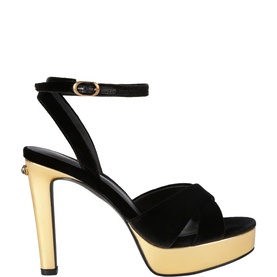 Kurt Geiger London black suede platform sandal with crossover toe strap, ankle buckle, and gold metallic stiletto heel and platform sole.