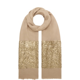 FeeG gold shawl with wide gold sequin embellished band on soft beige fabric, frayed hem edges