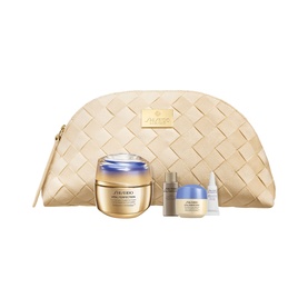 Shiseido Vital Perfection skincare gift set with cream, serum, moisturiser, and gold woven cosmetic pouch
