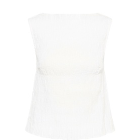 White sleeveless textured top with gathered waist detail, shot flat against white background