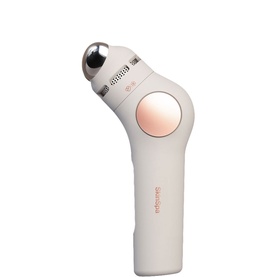 Theragun white handheld massage device with rose gold roller head and circular attachment, compact ergonomic design