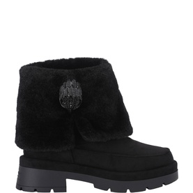 Black suede ankle boot with foldover shearling cuff, logo badge detail, and chunky black lug sole