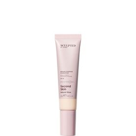 Sculpted by Aimee Second Skin Natural Glow Foundation in a pale pink tube with pump nozzle, complexion foundation.