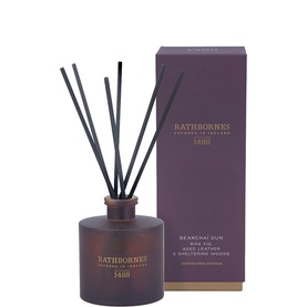 Rathbornes Seancha&iacute; D&uacute;n Scented Reed Diffuser 200ml in plum glass vessel with six black reeds, shown beside matching purple gift box.