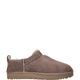 UGG Australia grey suede slip-on slipper shoe with shearling trim and tan ribbed sole, side view